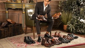 Man Sitting in Leather Armchair Picking Shoes