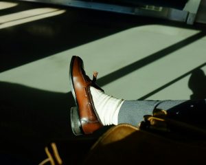 Stylish male sitting indoors at bright day