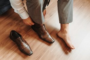 Elegant Man Putting on Expensive Shoes