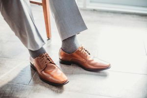 Person Sitting and Wearing Dress Pants and Shoes