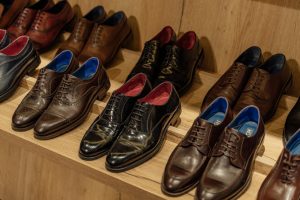 Brown Leather Shoes on Brown Wooden Shelf